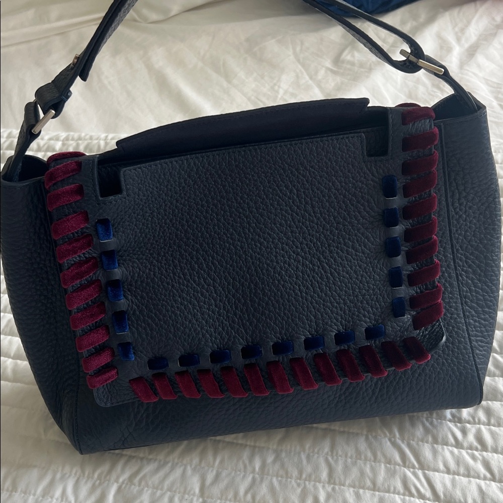 Orciani navy blue with burgundy and blue velvet accents.